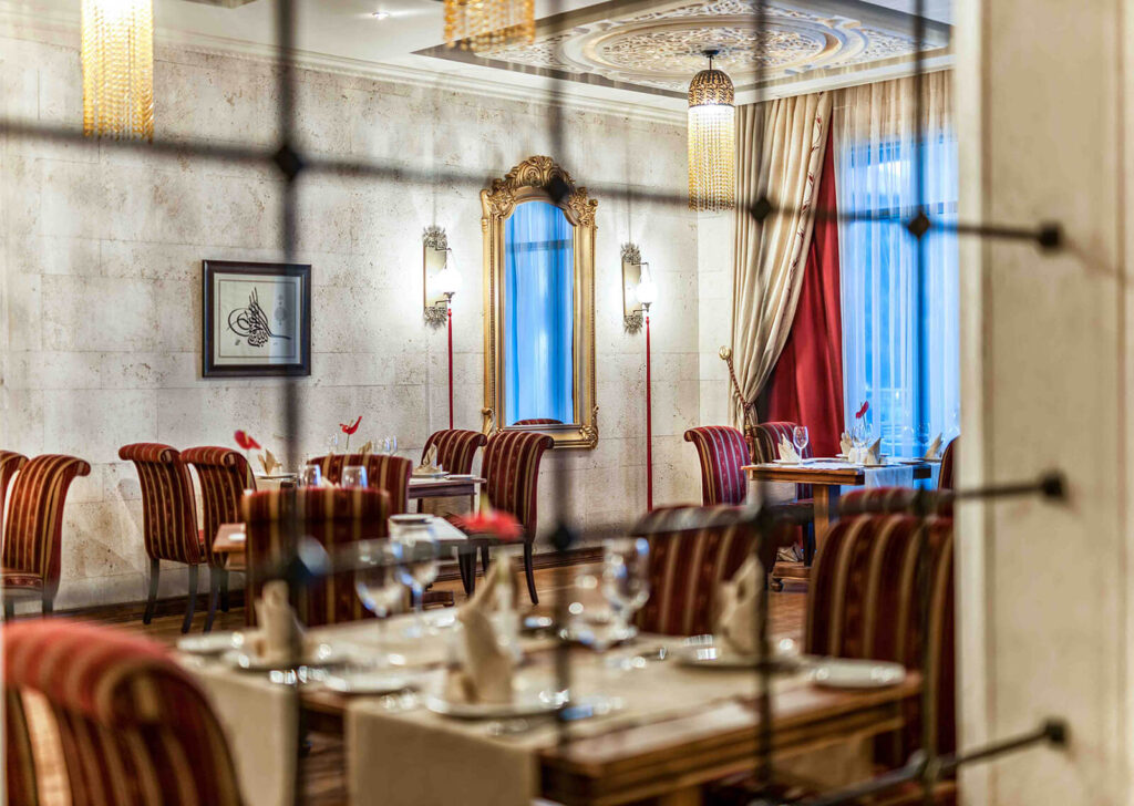 Fine dining restaurant interior with luxurious decor at Ela Quality Hotel in Antalya