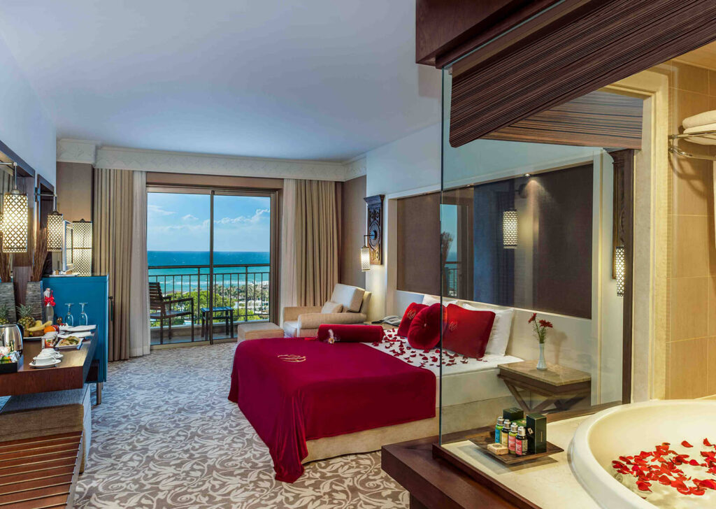 Romantic suite with sea view at Ela Quality Hotel in Antalya, featuring elegant decor and rose petals