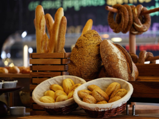 Close-up of freshly baked bread, baguettes, and simit at the Ibis Hotel Tuzla breakfast buffet.