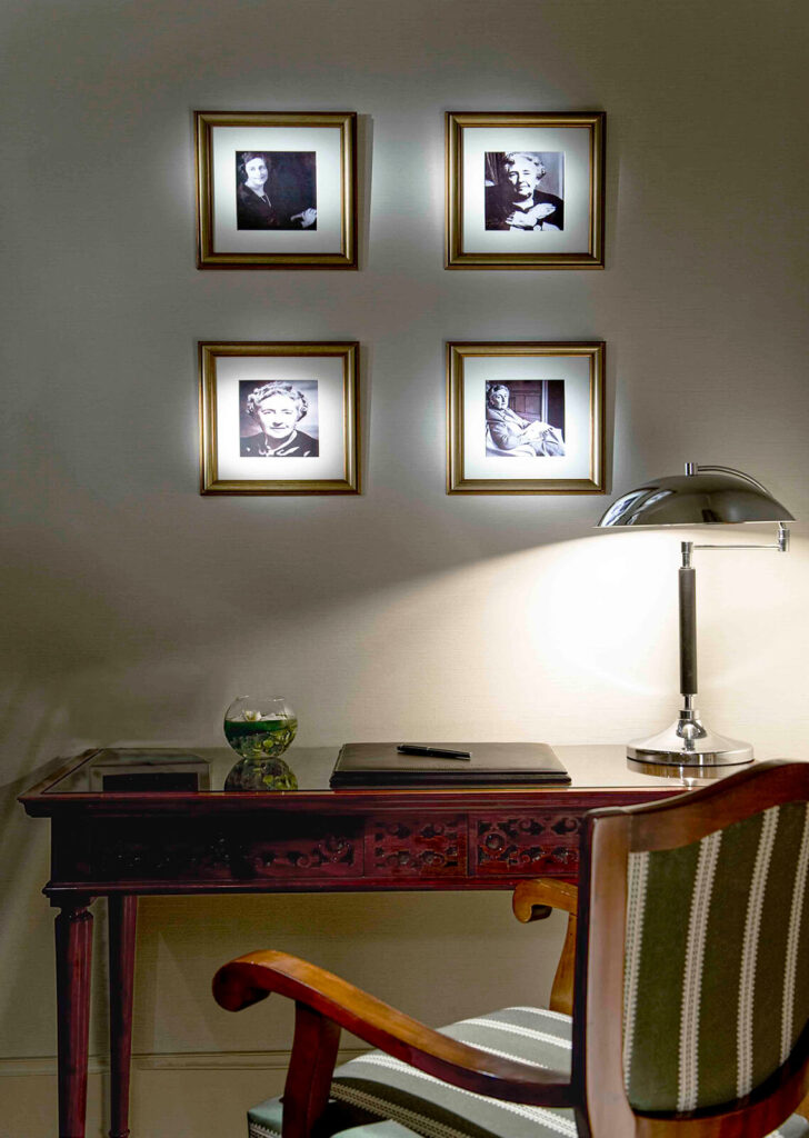 Vintage writing desk with classic decor and framed portraits at Pera Palace Hotel in Istanbul.